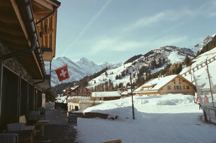 Snow-covered Swiss mountain village with a Swiss flag